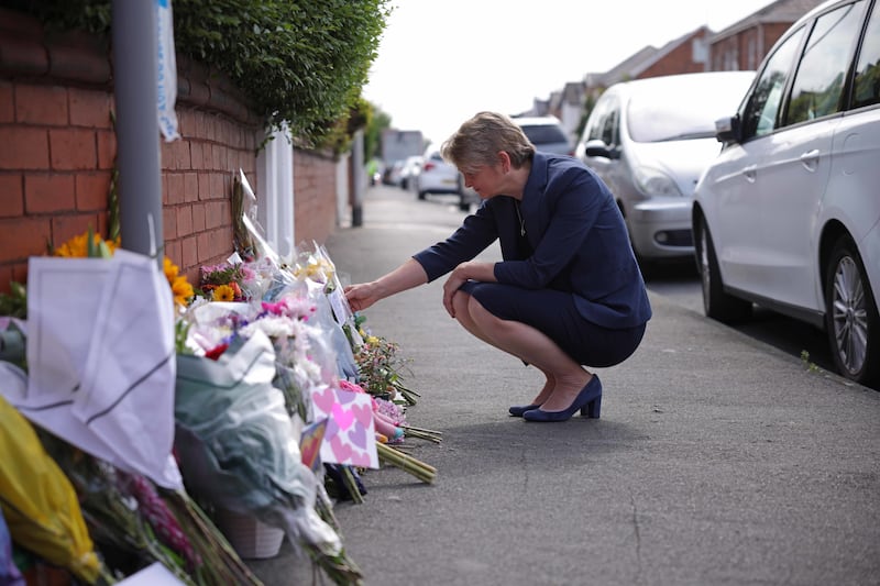 Home Secretary Yvette Cooper looks at tributes in Hart Street, Southport, close to where three children died in a knife attack