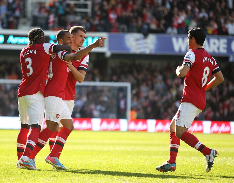 Theo Walcott (second left) played with Mikel Arteta (right) under Arsenal boss Arsene Wenger