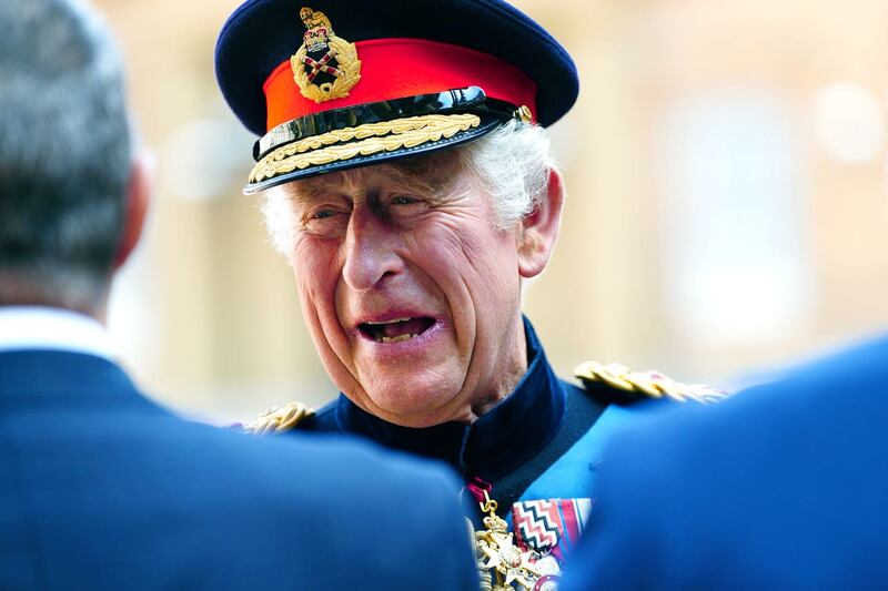 The King laughs with guests at the ceremony