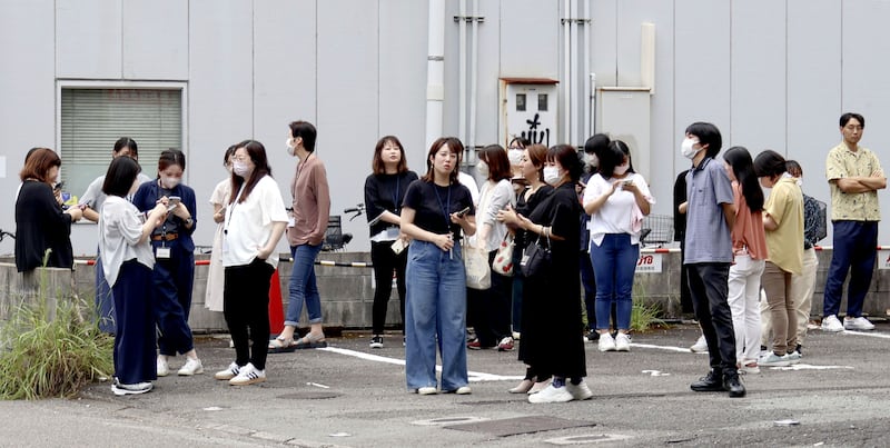 People gather outside a building following the earthquake in Miyazaki, western Japan (Kyodo News/AP)