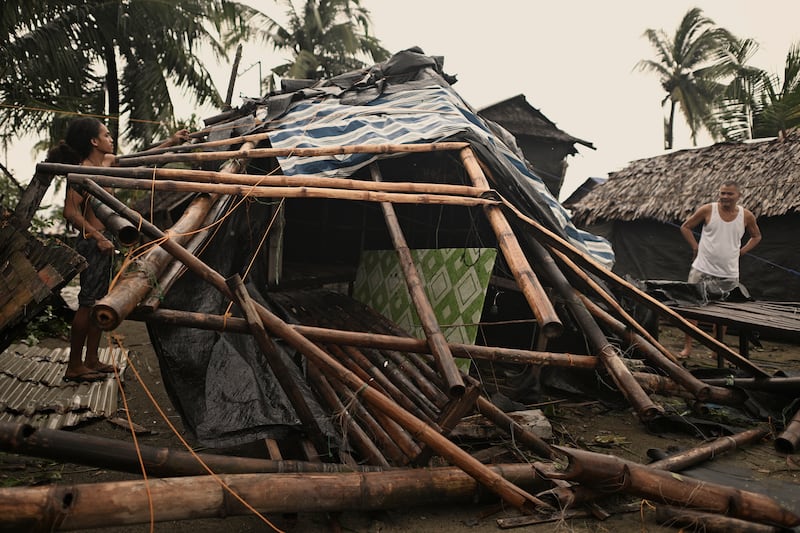 A resident checks his home that was damaged by Typhoon Man-yi in the municipality of Baler (Noel Celis/AP)