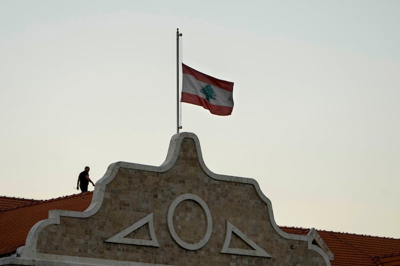 The Lebanese flag flies at half-mast at Lebanon’s government palace following the death of Hezbollah leader Hassan Nasrallah (Bilal Hussein/AP)