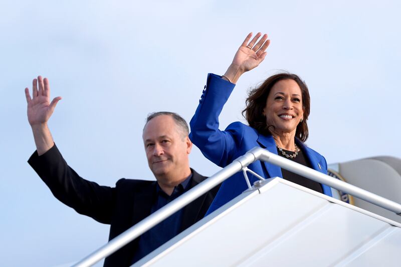 Democratic presidential nominee Vice President Kamala Harris, right, and second gentleman Doug Emhoff wave as they board Air Force Two (Julia Nikhinson/AP)