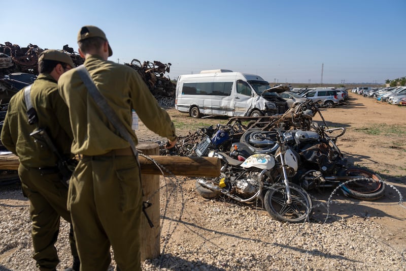 Israeli soldiers look at destroyed motorcycles outside the town of Netivot in southern Israel (Ariel Schalit/AP)