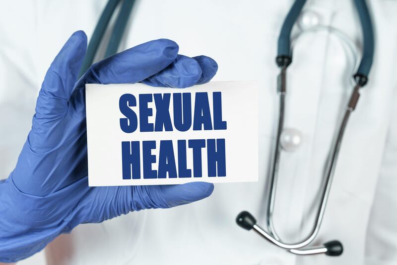 Doctor holding a sexual health card 