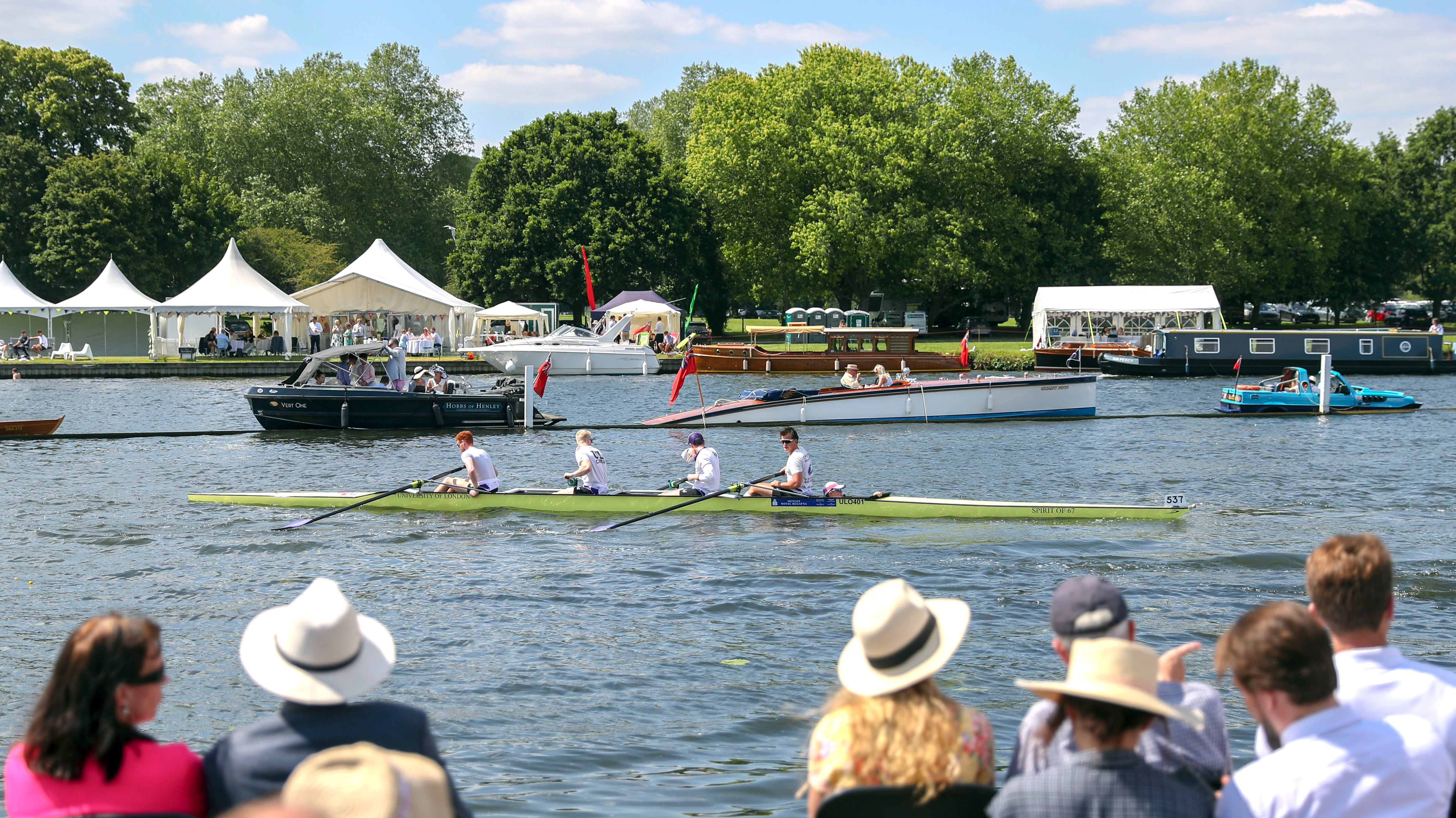 Spectators on the opening day of the 2019 Henley Royal Regatta alongside the river Thames