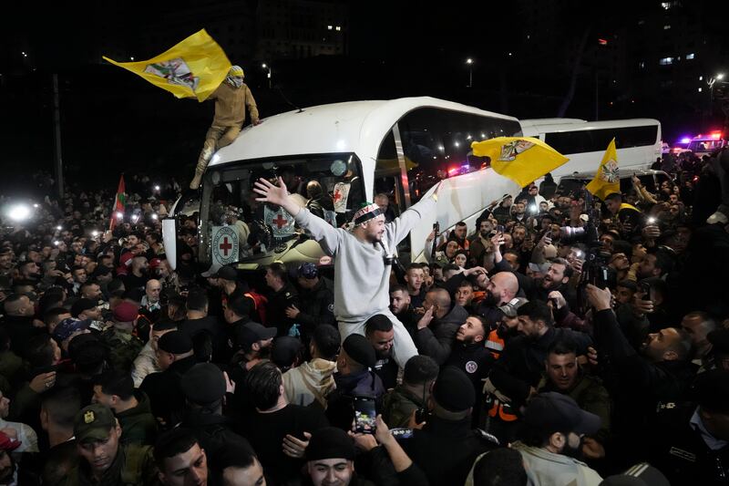 A crowd greets Palestinian prisoners after being released from Israeli prison following a ceasefire agreement between Israel and Hamas (Mahmoud Illean/AP)