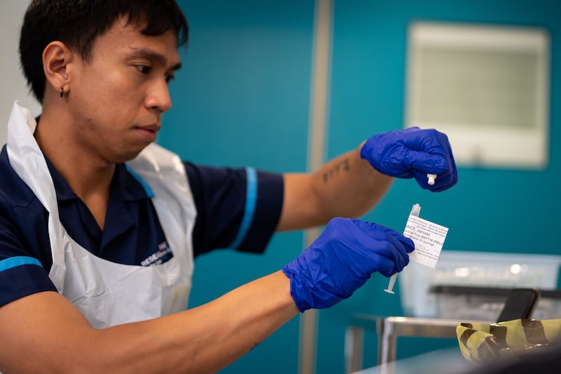 Keenjee Nama, senior research nurse, holds an injection of a BioNTech mRNA cancer immunotherapy for non-small cell lung cancer