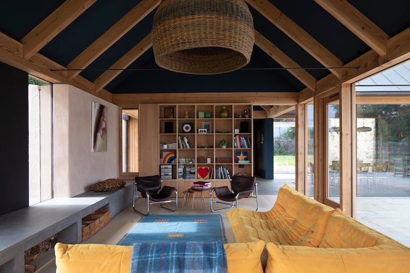 Contemporary Douglas fir single storey extension. A beautifully simple structure, with two longitudinal eaves beams supporting pairs of common rafters to form the pitched roof. Finished with larch cladding, frameless glazing, and lime-rendered walls, creating a modern, open plan space with plenty of natural light