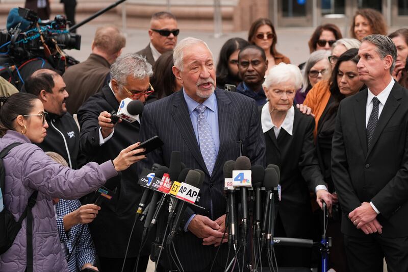 Joined by family members of Erik and Lyle Menendez, lawyer Mark Geragos, centre, speaks during a news conference after a hearing in Los Angeles (Jae C Hong/AP)