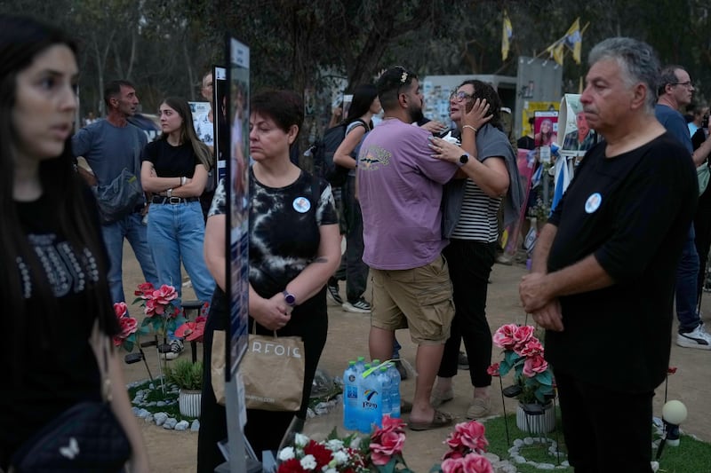 People visit the site of the Nova music festival, where hundreds of revellers were killed and abducted (Ariel Shalit/AP)