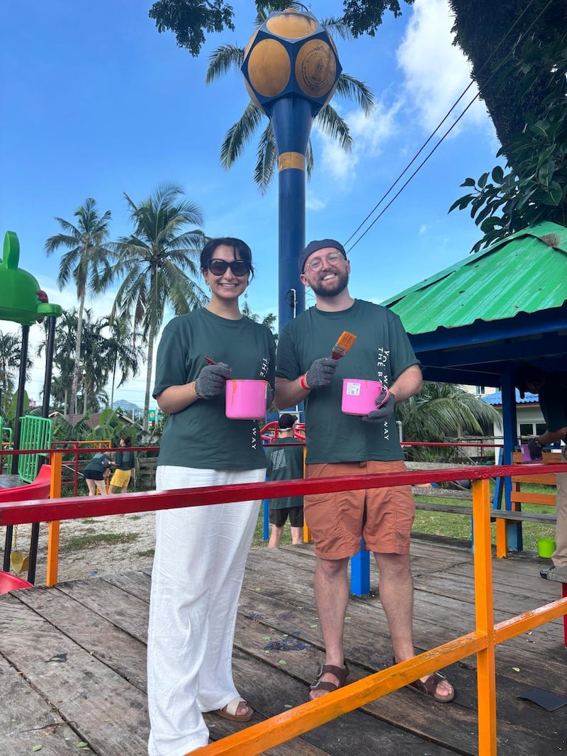 Author Luke O’Reilly, right, paints the playground at a local primary school alongside fellow guest Hiyah Zaidi.