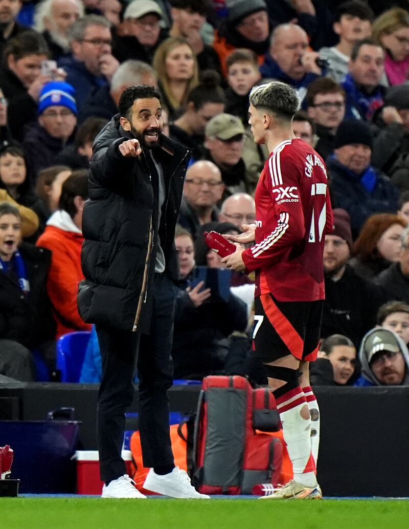 Alejandro Garnacho, right, receives instructions from Ruben Amorim