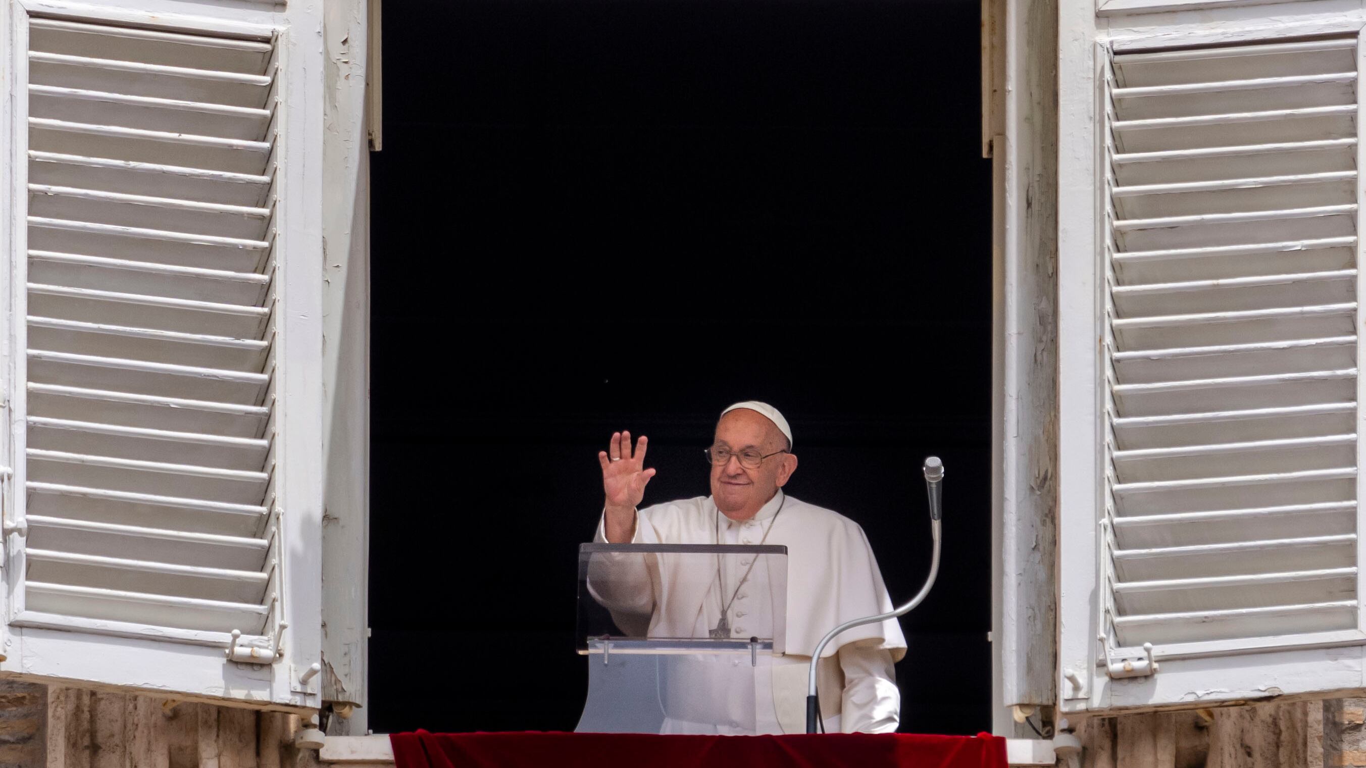Pope Francis waves from his studio’s window overlooking St Peter’s Square at The Vatican on Sunday (Domenico Stinellis/AP)