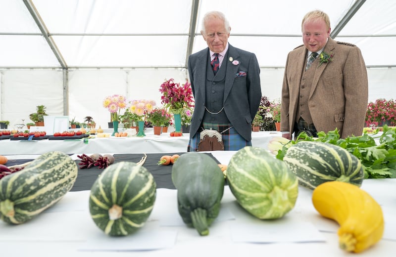 The King and horticultural society chairman Brian Grant view the vegetable entries