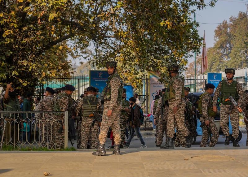 Indian paramilitary soldiers inspect the site of a grenade explosion at a marketplace in Srinagar, in Indian-controlled Kashmir (Mukhtar Khan/AP)