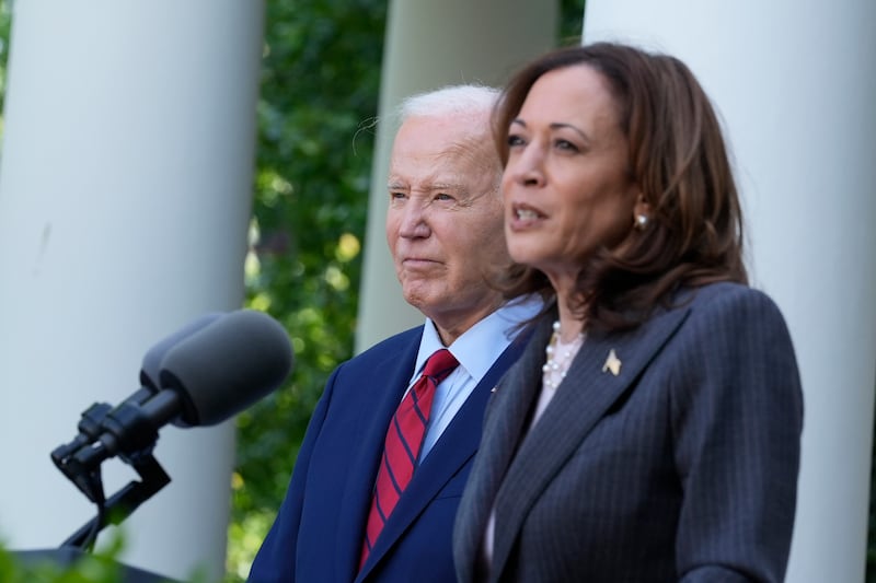 President Joe Biden listens as Vice President Kamala Harris speaks in the Rose Garden of the White House in Washington (Susan Walsh/AP)