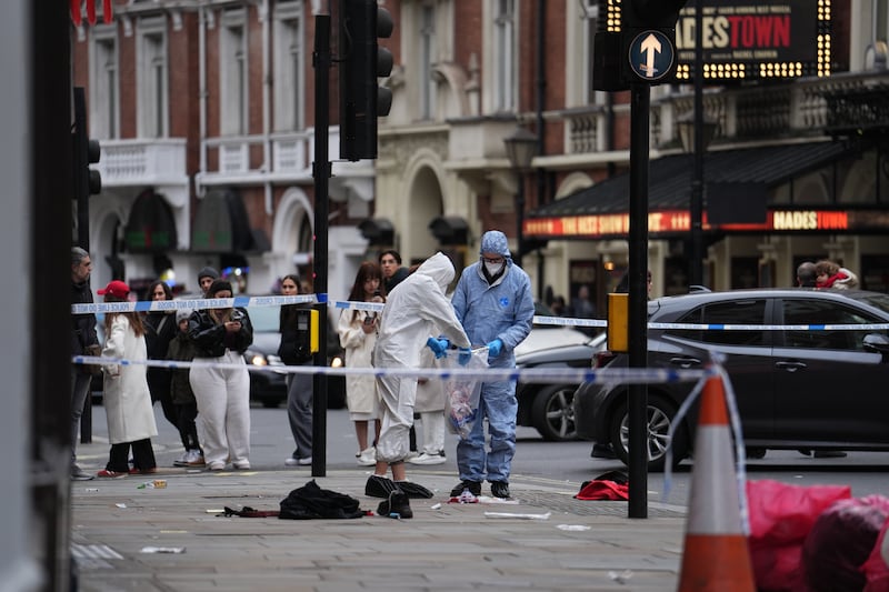 Forensic investigators collect evidence at the scene on Shaftesbury Avenue