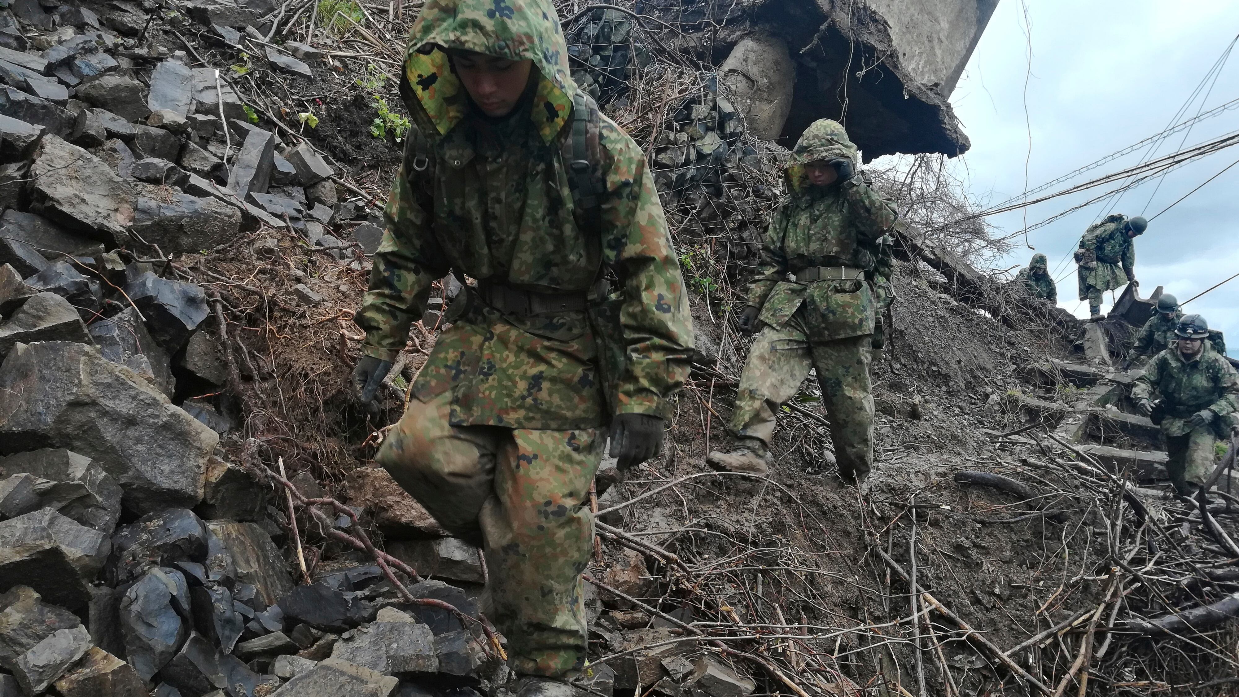 Members of the Japan Self-Defence Forces carry relief goods to an isolated area in Wajima, Ishikawa prefecture (Japanese Ministry of Defence/AP)