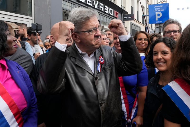 France Unbowed leader Jean-Luc Melenchon, centre, joins a protest in Paris on Saturday (Michel Euler/AP)