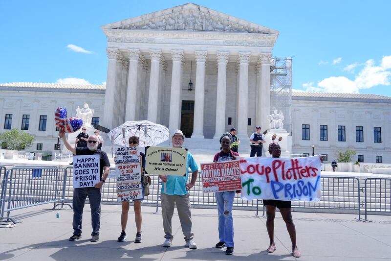 People protest outside the Supreme Court on Monday (Mariam Zuhaib/AP)