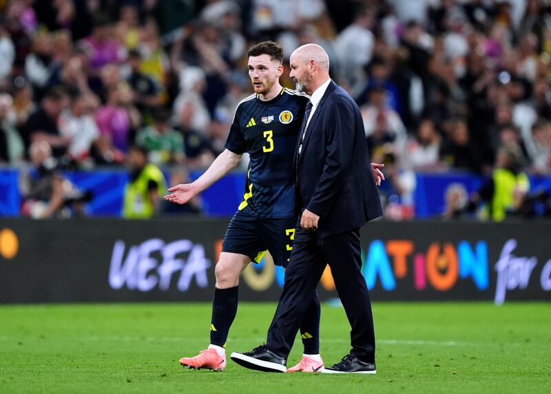 Robertson speaks to manager Steve Clarke after defeat to Germany