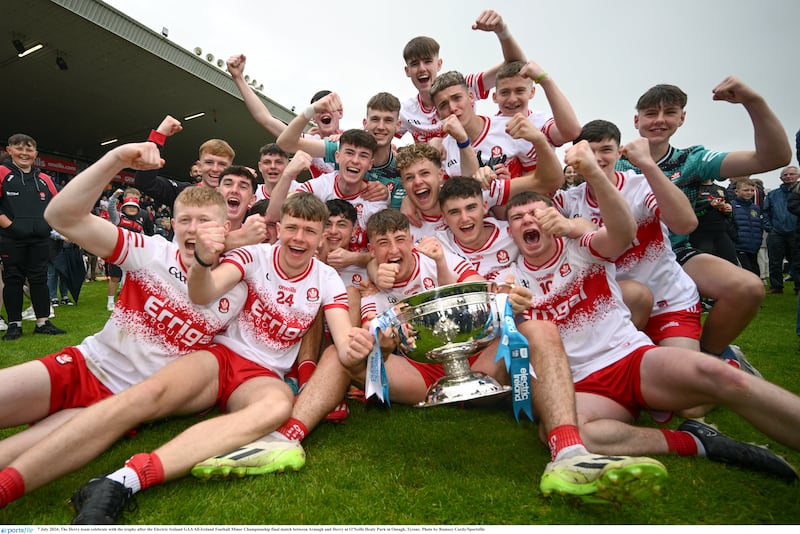 The Derry team celebrate with the trophy after the Electric Ireland GAA Minor Football Championship final match between Armagh and Derry at O'Neills Healy Park in Omagh