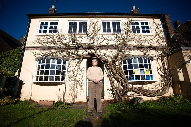 Justine Bayley, 74, poses outside her house in the village of Harmondsworth, west London. Photo credit should read: James Manning/PA Wire