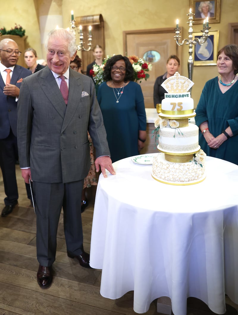 The King next to a birthday cake during his 75th birthday party at Highgrove Gardens in Tetbury on the eve of his birthday last year