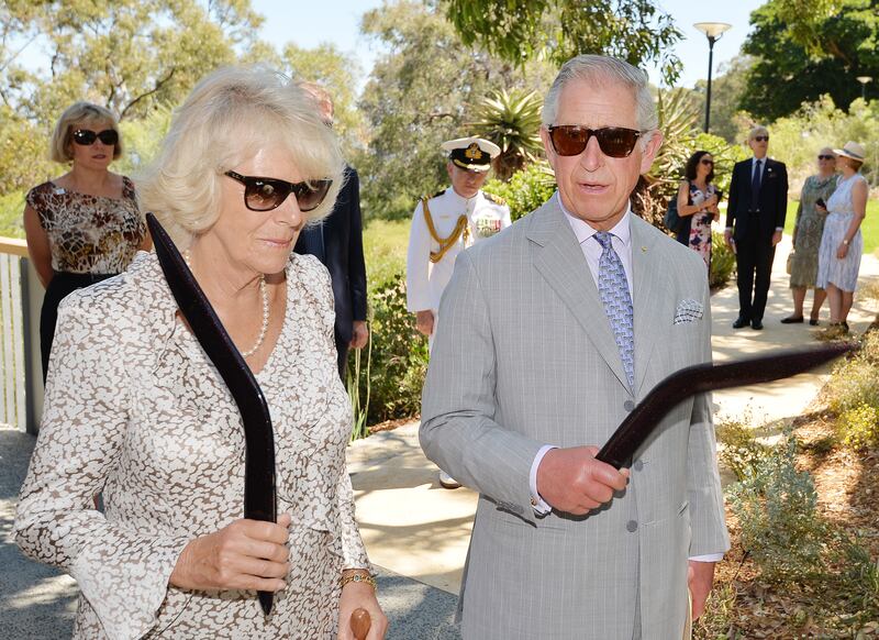 The then-Prince of Wales and Duchess of Cornwall holding their boomerangs in 2015