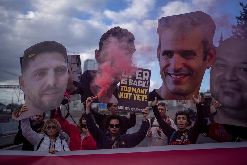 Relatives and supporters of Israelis held hostage in the Gaza Strip hold photos depicting their faces during a protest demanding their release from Hamas captivity (Oded Balilty/AP)