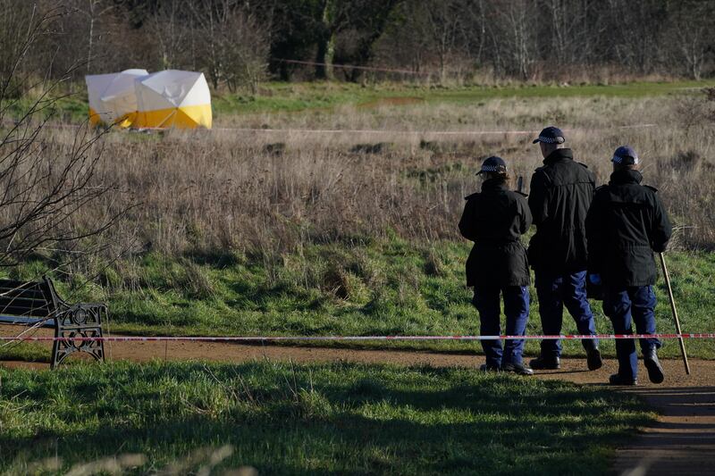 Forensic tents and a police search team at the scene at Hanworth Park