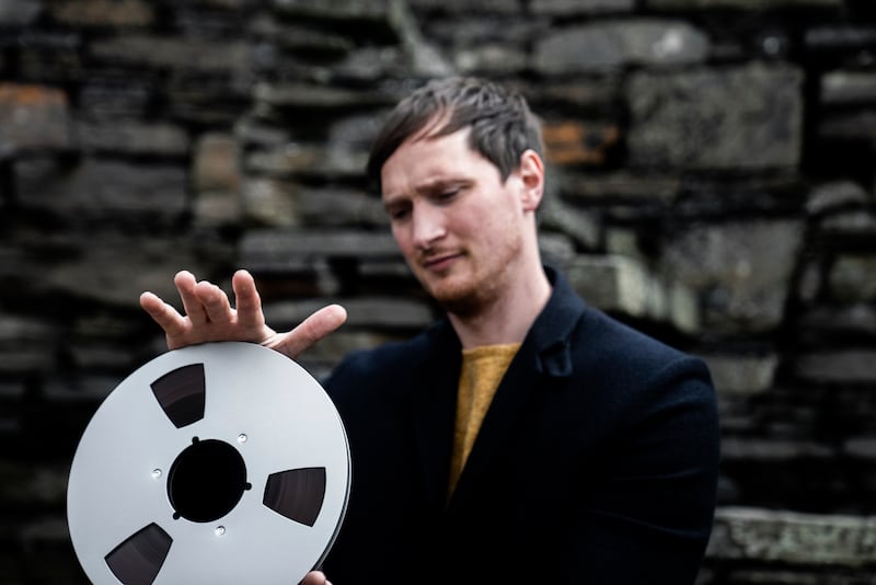 Erland Cooper holds his upcoming album, which survived for three years buried beneath Orcadian soil.
