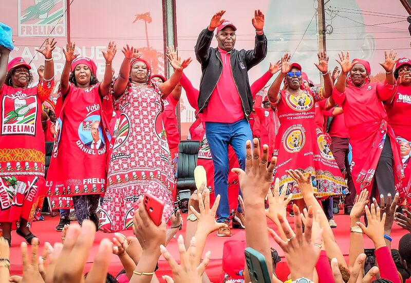 Supporters take part in a ruling party rally for presidential candidate Daniel Chapo, centre, in Maputo (Carlos Uqueio/AP)