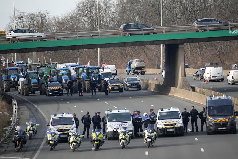 Police monitor a farmers’ demonstration in Argenteuil, north of Paris (Christophe Ena/AP)