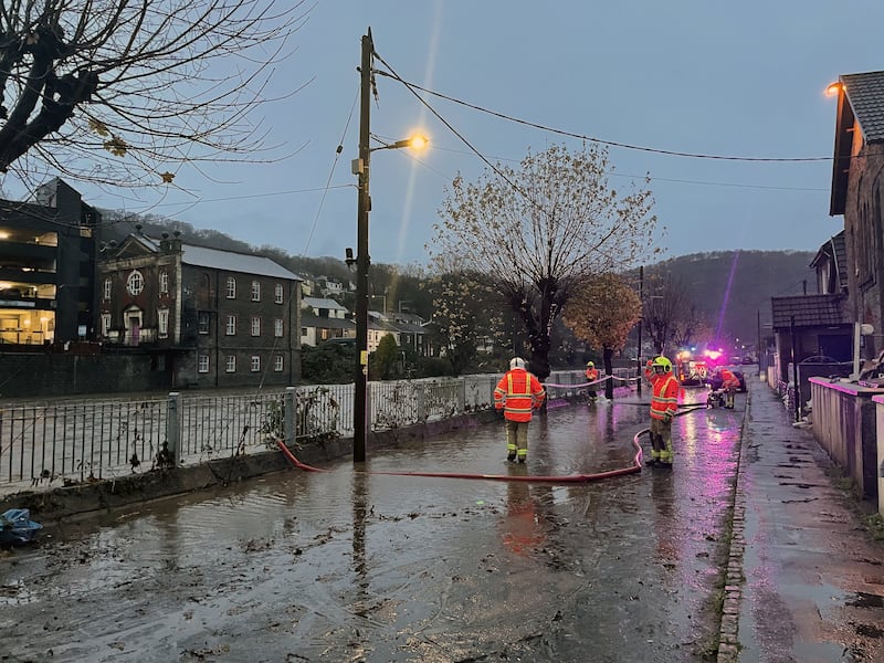 Firefighters pumping flood waters on Sion Street in Pontypridd, Wales