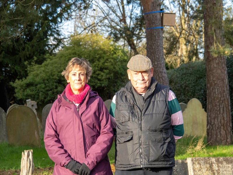 Chris and Diane Whitfield standing in a cemetery that could soon be surrounded by pylons