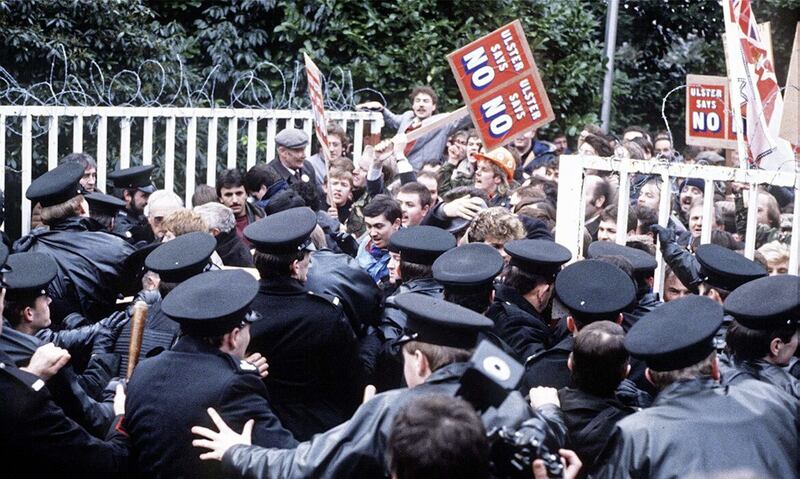 Loyalist protesters clash with RUC officers at the gates of the Maryfield Secretariat, set up as part of the Anglo-Irish Agreement in 1985. Picture: Pacemaker. 
