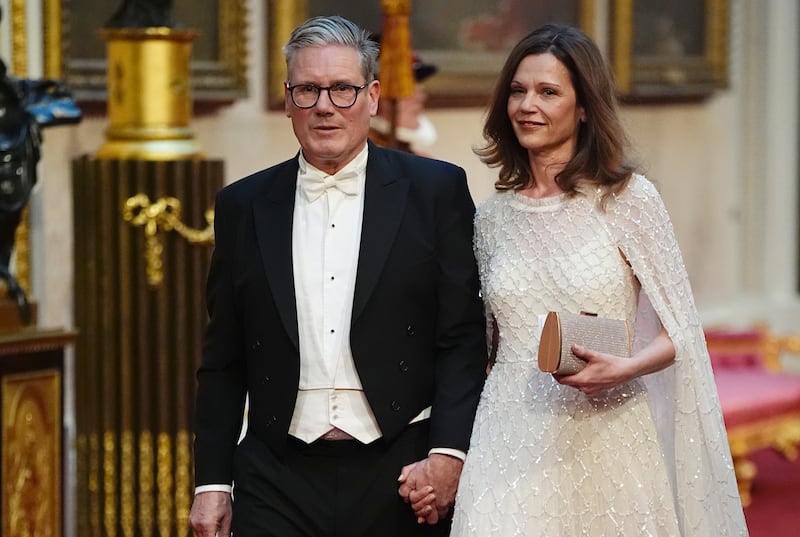 Labour leader Sir Keir Starmer with his wife, Victoria, make their way along the East Gallery to attend the state banquet for Emperor Naruhito