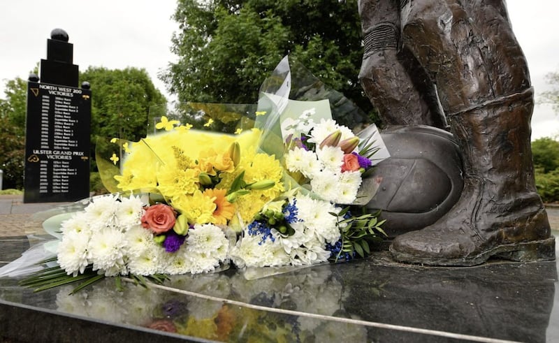 Fresh flowers placed at the feet of a bronze statue of Robert Dunlop in Ballymoney 