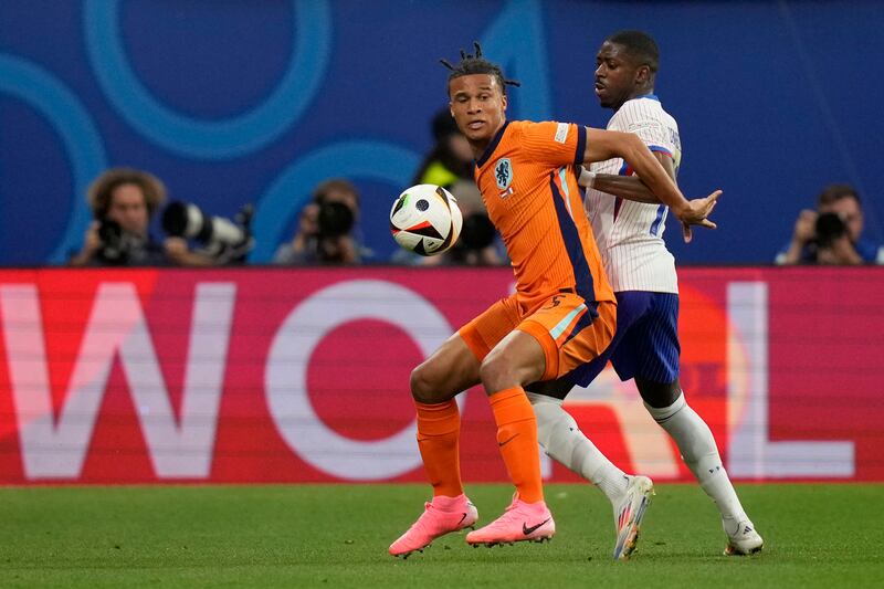 Nathan Ake of the Netherlands, left, is challenged for the ball by Ousmane Dembele of France during a Group D match (Mathias Schrader/AP)