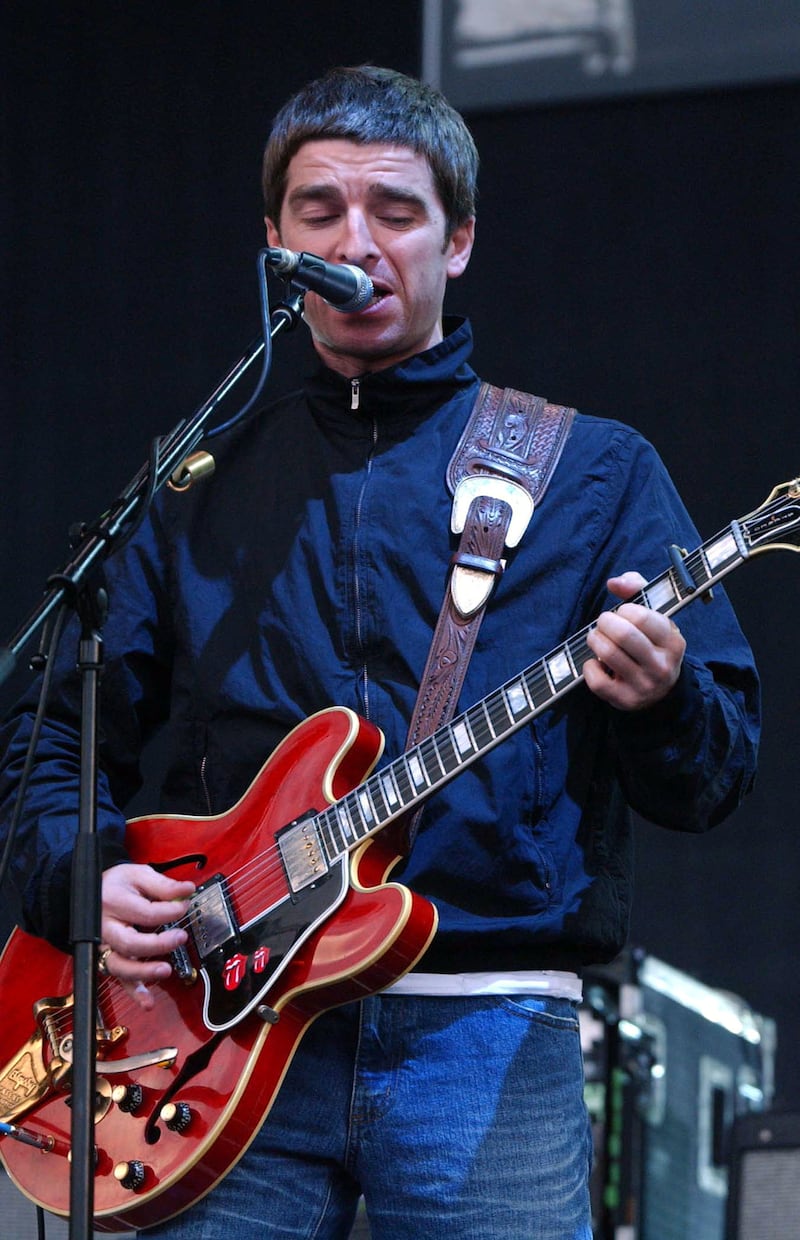 Noel Gallagher performing on stage