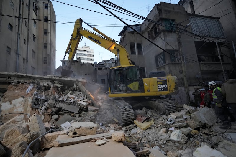 Rescuers use an excavator as they search for victims at the site of an Israeli air strike in Beirut, Lebanon (Hassan Ammar/AP)