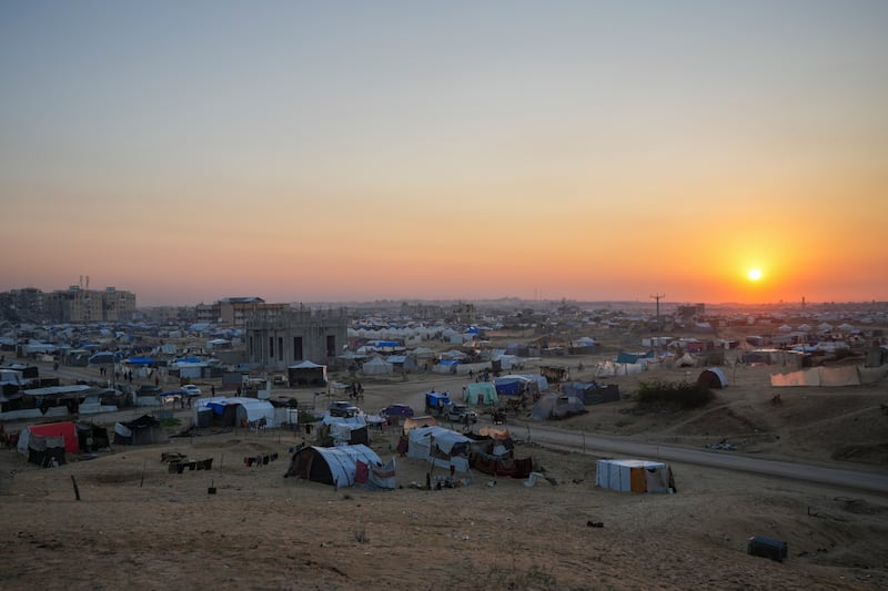 The sun sets over a tent camp for displaced Palestinians in the central Gaza Strip town of Khan Younis (AP Photo/Abdel Kareem Hana)