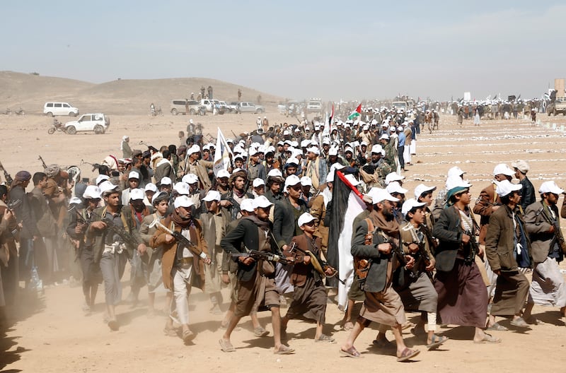 Houthi fighters march during a rally of support for the Palestinians in the Gaza Strip and against the US strikes on Yemen outside Sanaa in January (AP Photo, File)