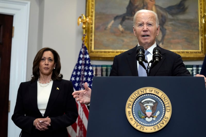 US President Joe Biden speaking in the Roosevelt Room of the White House as Vice President Kamala Harris listens (Susan Walsh/AP)