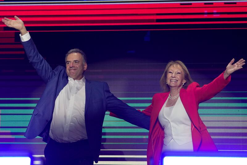 Mr Orsi and his running mate Carolina Cosse celebrated after the polls closed (AP)