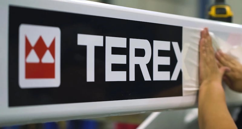 Hand pulling the seal off new branded Terex signage.