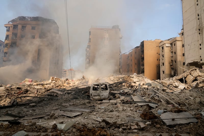 Smoke rises from destroyed buildings in Beirut’s southern suburbs on Saturday morning (Hussein Malla/AP)