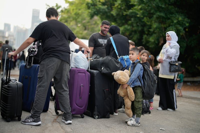 People wait to board a military ship evacuating them from Lebanon to Turkey (Emrah Gurel/AP)